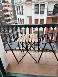 a group of chairs sitting on a balcony at Habitación con baño individual in Bilbao