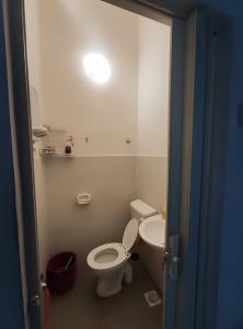 a bathroom with a toilet and a sink at Rumah teres 2 tingkat & 3 bilik in Pasir Gudang