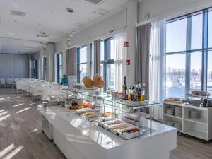 a buffet line with food on display in a room with windows at Seaside Glass Villas in Kemi