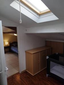an attic room with a skylight and a room with a bed at L'hirondelle du faubourg in Bar-sur-Aube