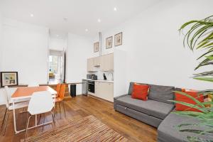 a living room with a couch and a table at New 1 Bedroom flat right on Broadway Market! in London