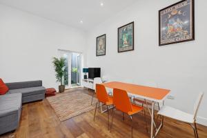 a living room with a table and chairs and a couch at New 1 Bedroom flat right on Broadway Market! in London