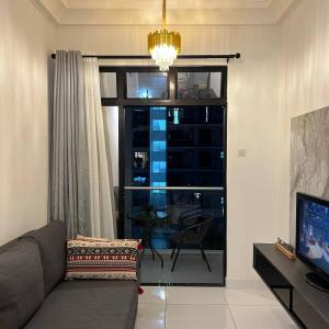 a living room with a couch and a window at Paradigm Mall 1BR-Poolview-Netflix-WiFi by JB RelaX Homestay in Johor Bahru