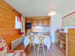 a kitchen with a table and chairs in a room at Appartement cosy avec piscine - 4 pers, balcon, parking - près des Saisies - FR-1-594-156 in Villard-sur-Doron