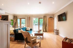 a living room with a couch and a bed at Granby Estate The Old Pool House in Bradford on Avon