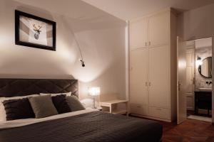 a bedroom with a large bed and a bathroom at LA apartments in Maribor