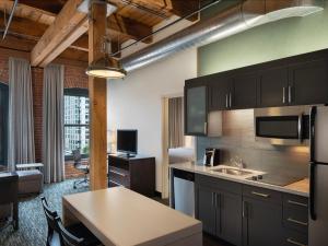 a kitchen with a sink and a table in a room at Residence Inn by Marriott Boston Downtown Seaport in Boston