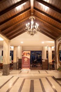 a large lobby with a chandelier and a sign at Rock Manali by Vivaan in Manāli