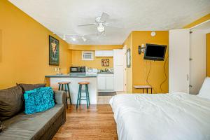 a room with a bed and a couch and a kitchen at Arrowhead Resort: Canary Condo in Saugatuck