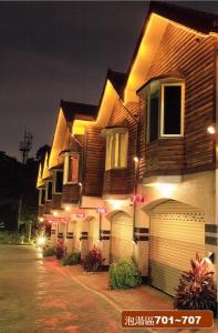 una casa con luces al costado de ella por la noche en Regale Motel, en Zhonghe