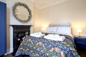 a bedroom with a bed with towels on it at Hurn Crag House, Stunning ground floor apartment near Southwold in Southwold