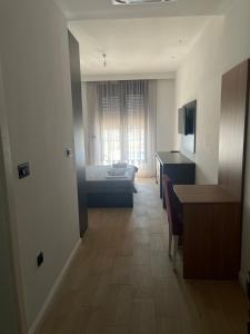 a room with a bedroom with a bed and a desk at Elia Residence Rooms in Bečići