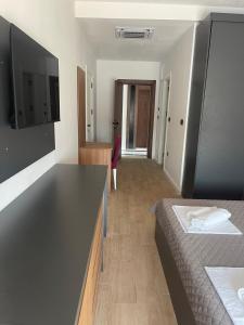 a hotel room with two beds and a desk at Elia Residence Rooms in Bečići +6 photos