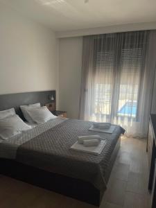 Postel nebo postele na pokoji v ubytování Elia Residence Rooms