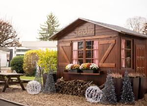 a small shed with christmas decorations in a yard at Crowne Plaza Geneva, an IHG Hotel in Geneva