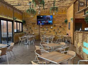 a restaurant with tables and chairs and a tv on a wall at Gulson Estates B&B in Parkside