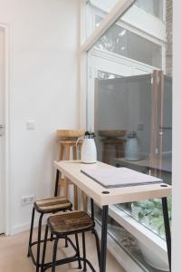 a table with two stools in front of a window at B&B Amsterdam West in Amsterdam