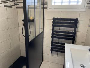 a shower with a glass door in a bathroom at Maison de la Mer in Saint-Germain-sur-Ay +21 photos