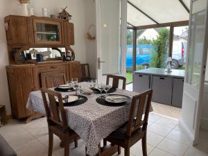a dining room with a table with glasses on it at Maison de la Mer in Saint-Germain-sur-Ay