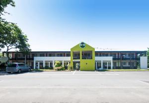 un parking en face d'un bâtiment dans l'établissement B&B HOTEL Brest Kergaradec Aéroport Gouesnou, à Brest