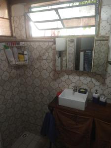 a bathroom with a sink and a mirror at Tiny home hexagonal de barro y techo vivo in Santa Ana