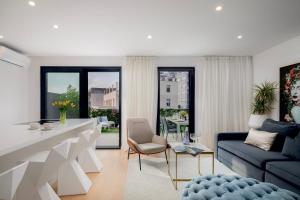 a living room with a couch and a table at Luxury apartment Enjoyer - PRIVATE POOL with a large garden and private garage in Split