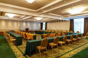 a conference room with tables and chairs and a podium at Midland Hotel Nakuru in Nakuru