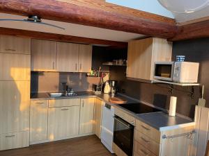 a kitchen with wooden cabinets and a white microwave at Abendrot in Uehrde