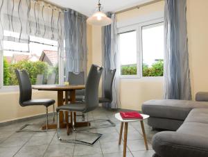 a living room with a table and chairs and a couch at Haus Kaltenhof in Insel Poel