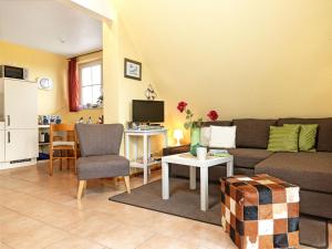 a living room with a couch and a table at FIP Park Seebrise in Insel Poel