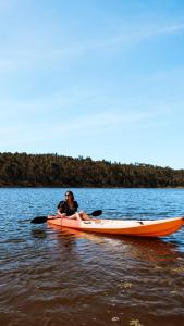 a woman sitting on a kayak in the water at Nature Forest - Herdade de Martingil in Chouto