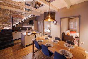 a dining room and kitchen with a table and chairs at Vila ROBIDA & SPA in Črni Kal