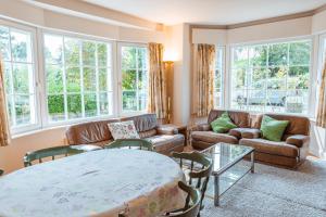 a living room with a couch and a table at La Marjolaine in De Haan