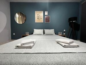 a bedroom with a large bed with two towels on it at Cozy house in Xanthi