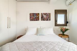 a bedroom with a large white bed with a mirror at Deluxe Suite near City Center in Heraklio