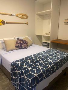 a bedroom with a bed with a baseball bat on the wall at Segunda Casa- Seu cantinho na Praia do Morro em Guarapari - Quartos suítes 2 até 4 pessoas in Guarapari