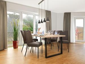 a dining room with a table and chairs at Haus Südwester Austernperle in Timmendorf