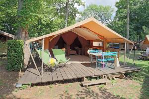 a tent with a table and chairs on a wooden deck at CityKamp Paris in Paris