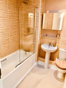 a bathroom with a shower toilet and a sink at Olympic Village Home - Victory in Portland
