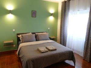 a bedroom with a large bed with two towels on it at Casa Fialli 