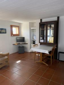 a living room with a table and a tv at Casa Vignole-Badasci in Orselina