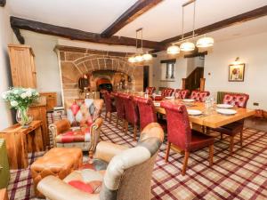 a dining room with a long table and chairs at Shore Hall in Littleborough