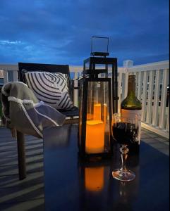 a table with a bottle of wine and a glass at Luna Retreat - Newbiggin by the Sea in Newbiggin-by-the-Sea +14 photos