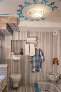 a bathroom with a toilet and a chandelier at Hotel Niles Istanbul in Istanbul