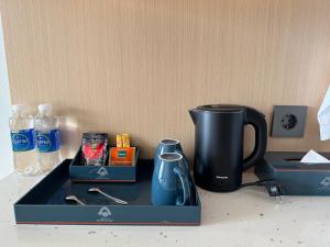 a black tray with a coffee maker and a cup at The Arena Cam Ranh Resort all Luxury Service in Miếu Ông
