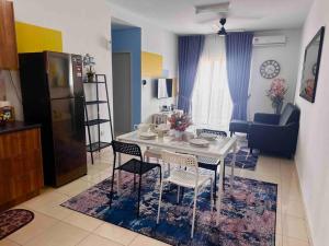 a kitchen and living room with a white table and chairs at AF Homestay 2 Bedrooms 15mins to KLIA Free Wifi Netflix in Sepang