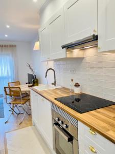 a kitchen with a sink and a stove top oven at Bright modern 3 BR in Portimao downtown in Portimão