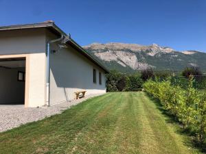 a bench sitting next to a building with mountains in the background at LE PIC PONCON in Gap +7 photos