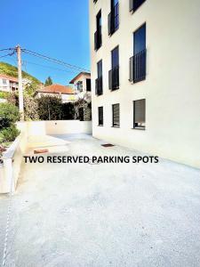 two reserved parking spots sign in front of a building at Fides Stylish Apartments Tivat with Pool in Tivat