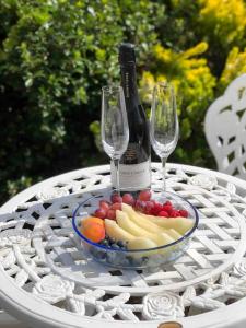 una botella de vino y un bol de fruta en una mesa en Spacious 2 Bedroom Flat in heart of Ballater en Ballater